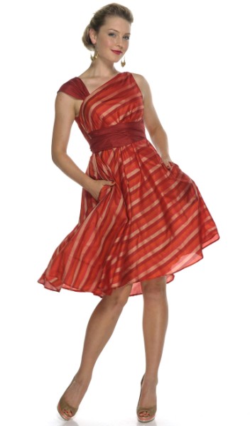Allegra Dress $299. The asymmetrical neckline and stripes draw attention up the body to your face, adding height. The tie cinches in the waist, making the voluminous silk fold down to nothing.